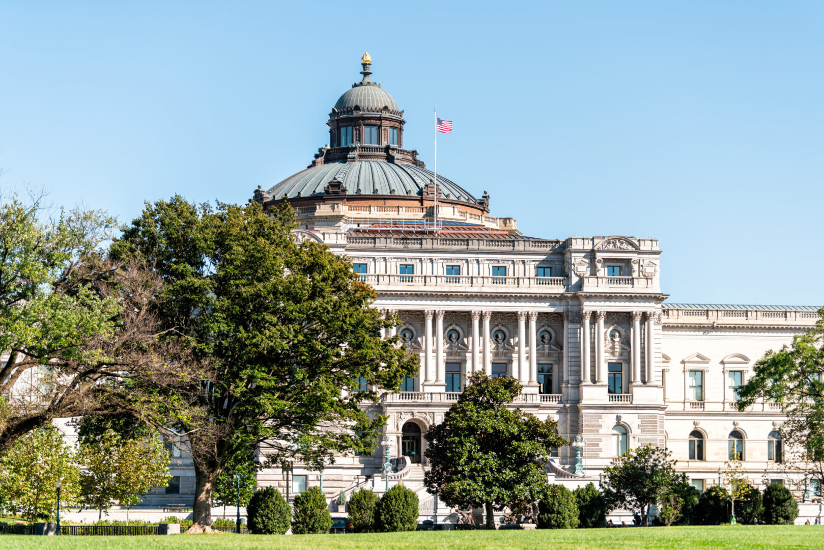 Historic building with dome and trees outside.